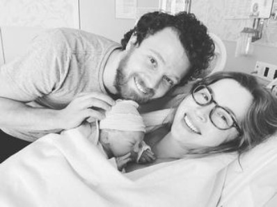 Josie Lynn Shalhoub and her husband, Traver, with their newborn baby son. 
